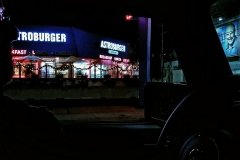 Driving past an Astro Burger and Dr. Phil sign.