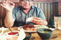 Mario eating carnitas, tortillas at a restaurant.