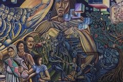 Los Angeles man walks by a mural painted by Paul Botello.